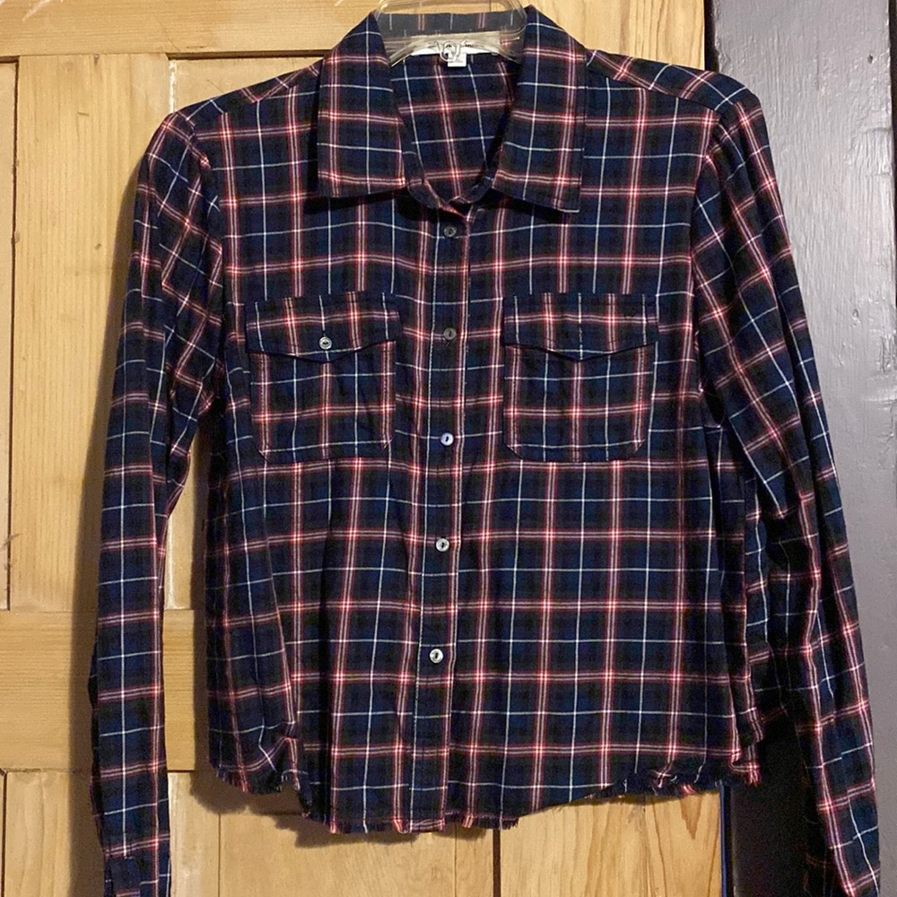Cropped plaid shirt with raw edge hem.